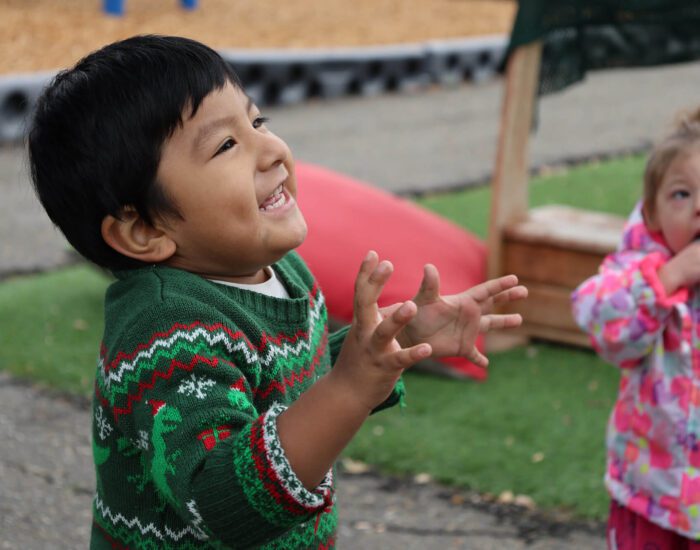 Young child looking up and smiling