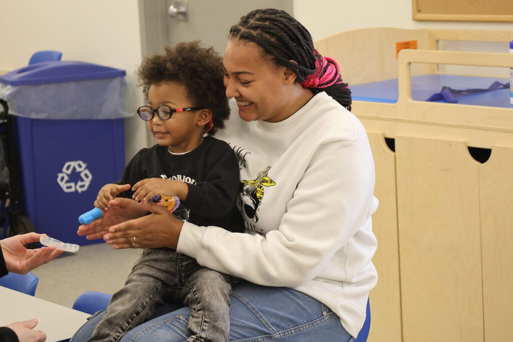 Childcare provider holding a child