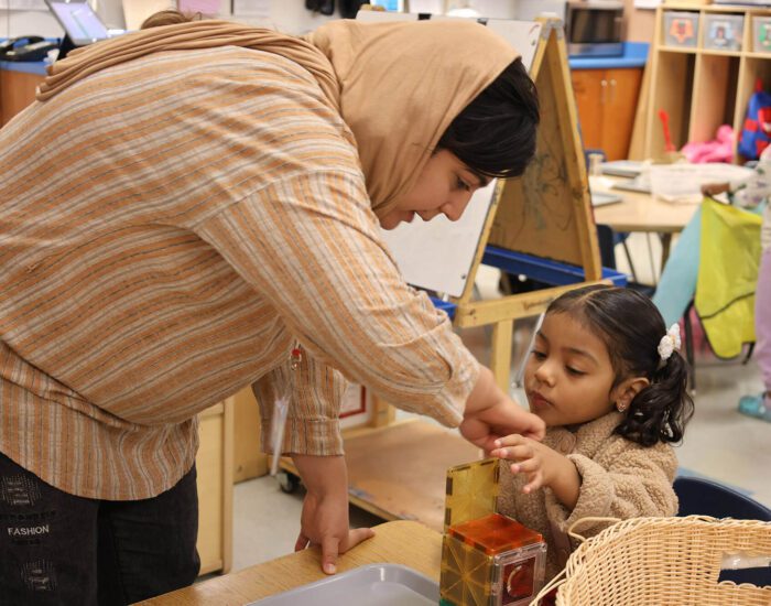 Teacher working with young student 